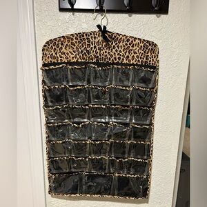 Organizer cheetah pint 26 x 17 32 pockets on both sides and hanger top.